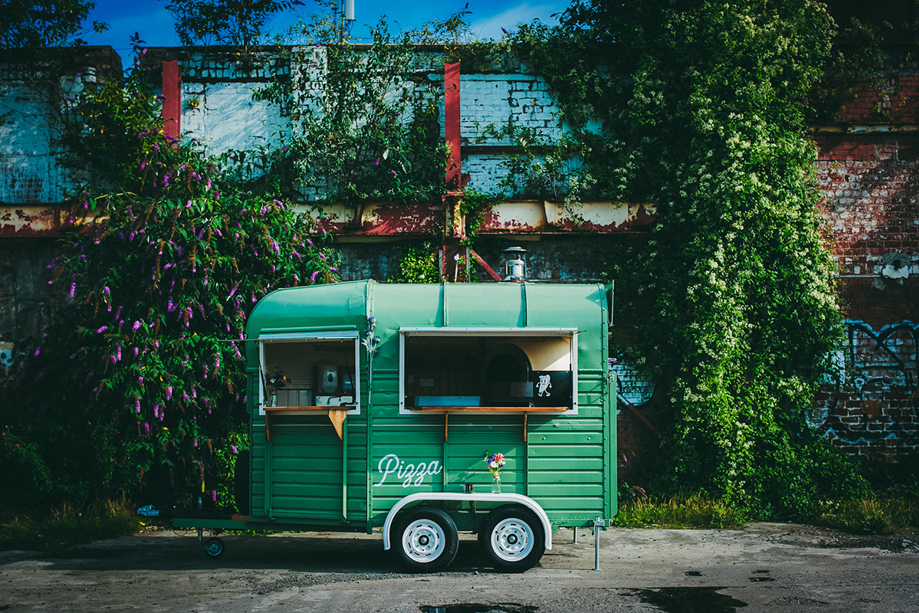 Green Dough Man's Land horsebox in front of leafy, floral background